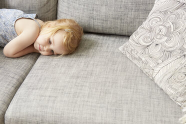 Müdes weibliches Kleinkind auf dem Sofa liegend - CUF15213