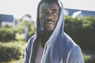 Portrait of man wearing hooded top looking away - CUF15286