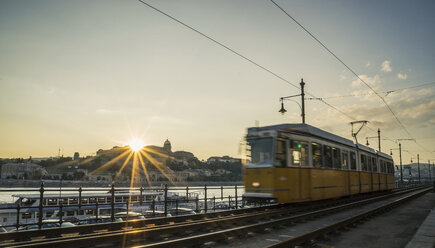 Tram at sunset along the Danube, Hungary, Budapest - CUF15895