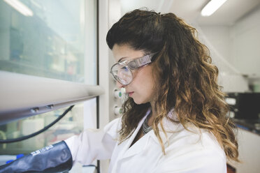 Female scientist preparing chemicals for sol-gel titania synthesis - CUF15921