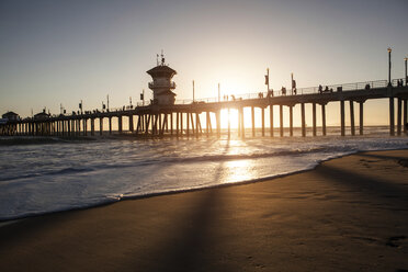 Silhouetted view of pier at sunset, Huntington Beach, California, USA - CUF16142