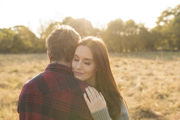 Young couple in rural setting, embracing - CUF16307