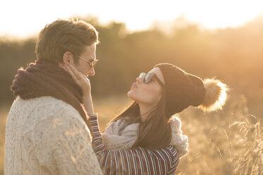 Young couple in rural setting, fooling around, face to face - CUF16311