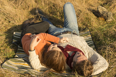 Young couple lying in field - CUF16330