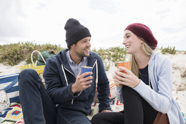 Young couple picnicking on beach, Western Cape, South Africa - CUF16336