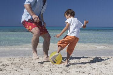 Junge spielt mit seinem Vater am Strand Fußball, Mallorca, Spanien - CUF16534