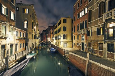 View of canal and traditional waterfront houses at night, Venice, Italy - CUF16802