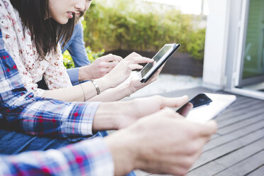 Cropped shot of designers using digital tablets on office roof terrace - CUF16896