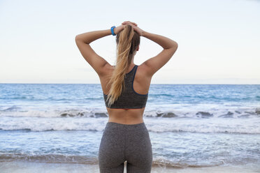 Rear view of young female runner on beach, Dominican Republic, The Caribbean - CUF17193