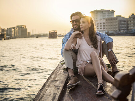 Romantic couple sitting on boat at Dubai marina, United Arab Emirates - CUF17238