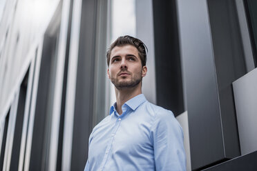 Young businessman in the city outside office building - DIGF04540