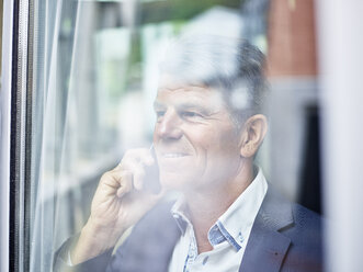 Portrait of mature businessman on cell phone - CVF00629