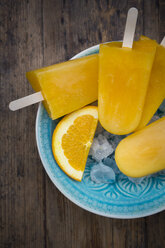 Home-made orange popsicles in bowl - LVF07009