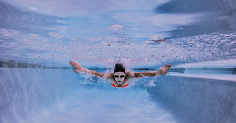 Swimmer performing butterfly stroke - ISF06461