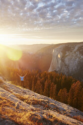 Hiker rejoicing on hill, Yosemite National Park, Sierra Nevada - ISF06545