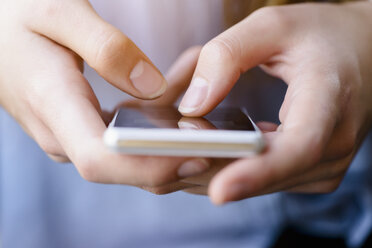 Cropped view of young womans texting on smartphone - CUF17486