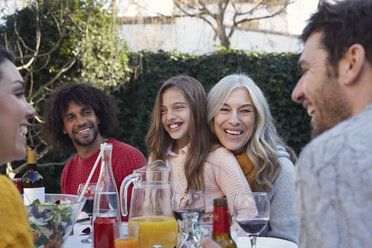 Multi generation family dining outdoors, smiling - CUF17687