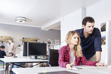 Colleagues in office using computer - CUF17753