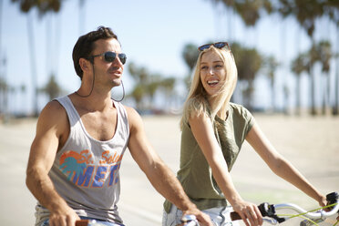 Couple on cycles at Venice Beach, Los Angeles, California, USA - ISF06645