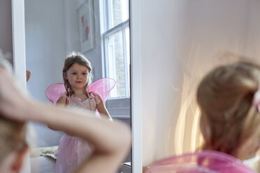 Girl in fairy costume looking into mirror - CUF17984