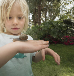 Blonde boy holding snail - ISF06722