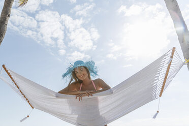 Portrait of young woman lying on hammock at Miami beach, Florida, USA - ISF06736