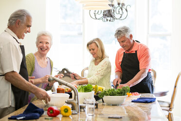 Group of seniors preparing meal in kitchen - ISF06879