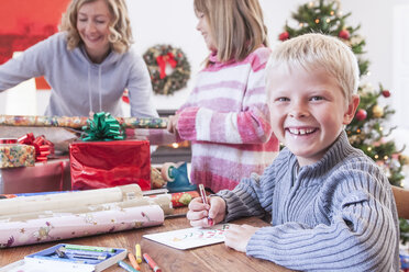 Mother and children wrapping christmas gifts - CUF18258