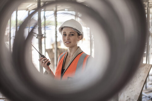 Portrait of female builder on construction site - ISF06980