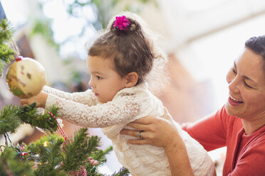 Mother and daughter decorating Christmas tree - ISF07108