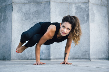 Woman in Side Crow pose (Parsva Bakasana) - ISF07142