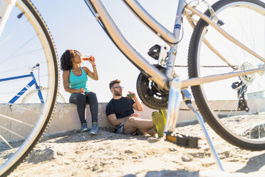 Ehepaar entspannt sich nach einer Fahrradtour, Fahrräder neben ihnen - ISF07144