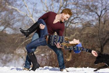 Young couple fooling around in snowy Central Park, New York, USA - ISF07228