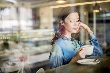 Beautiful woman at cafe window seat, Dubai, United Arab Emirates - CUF18938