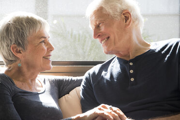 Senior couple sitting together, face to face, smiling - ISF07367