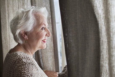 Senior woman looking out of window - ISF07394