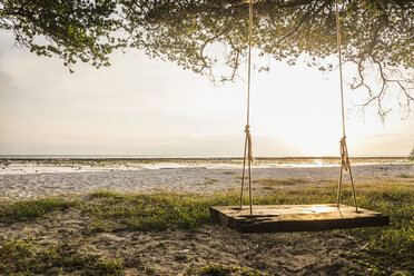 Empty beach tree swing at sunset, Gili Trawangan, Lombok, Indonesia - CUF18991