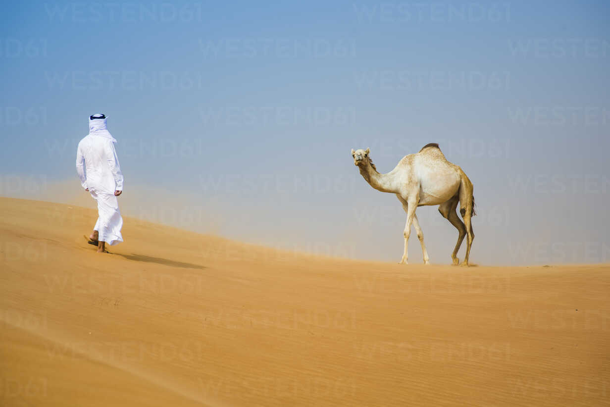 Middle eastern man wearing traditional clothes walking toward