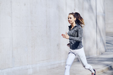 Female runner, concrete wall - BSZF00435