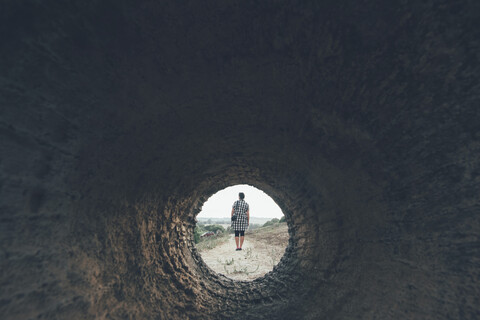 Rear view of woman through cylinder, Martis, Sassari, Italy stock photo