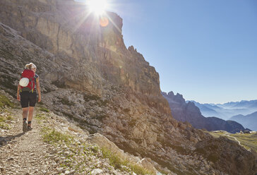 Rückansicht einer Wanderin beim Aufstieg in die Dolomiten, Sexten, Südtirol, Italien - CUF19952