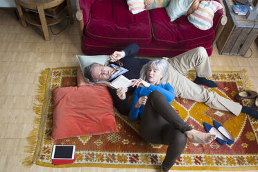 Couple reading book on floor - CUF20070