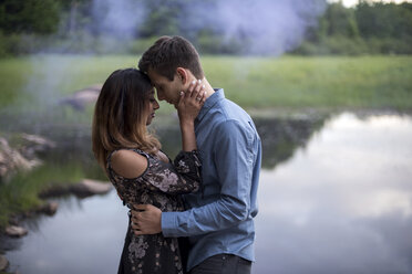 Couple hugging by lake, Ottawa, Ontario - ISF07458