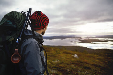 Wanderer genießt den Blick auf den See, Keimiotunturi, Lappland, Finnland - CUF20085