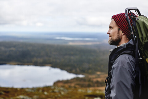 Wanderer genießt die Aussicht von der Klippe, Keimiotunturi, Lappland, Finnland, lizenzfreies Stockfoto