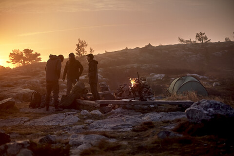 Hikers preparing for camp at sunset, Sarkitunturi, Lapland, Finland stock photo