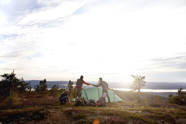 Hikers setting up tent, Keimiotunturi, Lapland, Finland - CUF20139