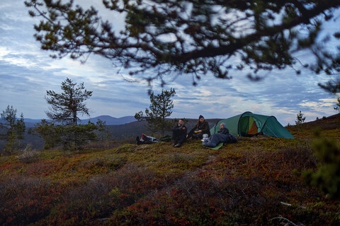 Wanderer beim Entspannen vor dem Zelt, Keimiotunturi, Lappland, Finnland, lizenzfreies Stockfoto