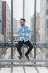 Young man sitting on fence - AFVF00585