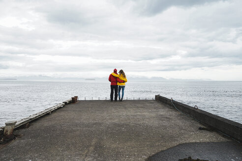 Iceland, North of Iceland, back view of couple standing on jetty looking at view - AFVF00599